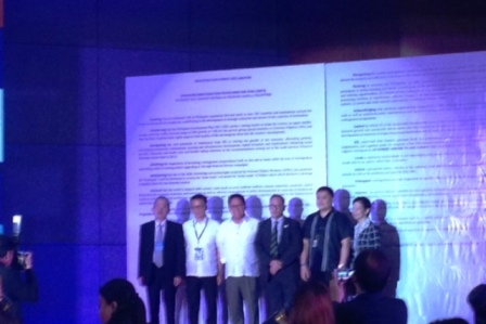 Secretary Silvestre Bello III of the Department of Labor and Employment (third from left), and other government officials stand in front of the Reintegration Summit Declaration.
